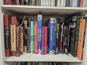 3rd shelf of our TTRPG bookshelf