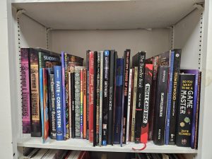 4th shelf of our TTRPG bookshelf